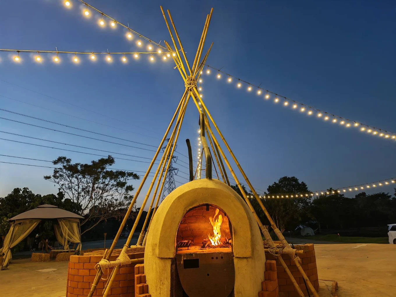 Outdoor fire place beneath warm string lights at Firefly Pattaya
