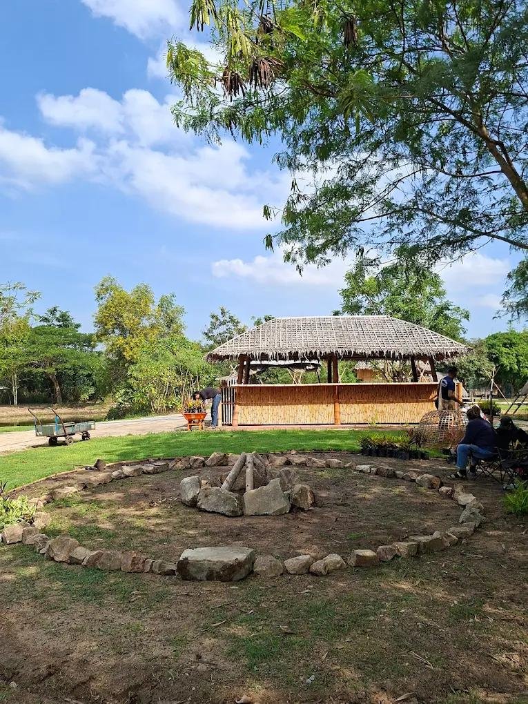 Stone campfire circle and rustic bamboo pavilion